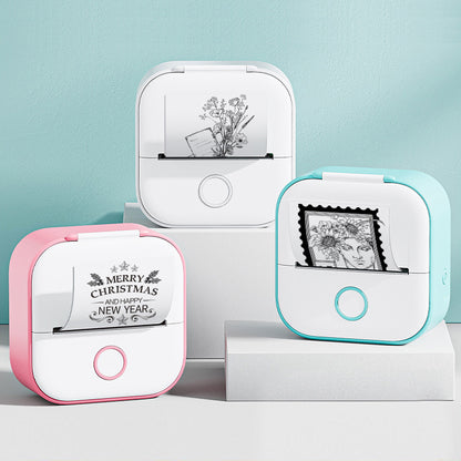 Three small printer devices with printed designs on a light blue background