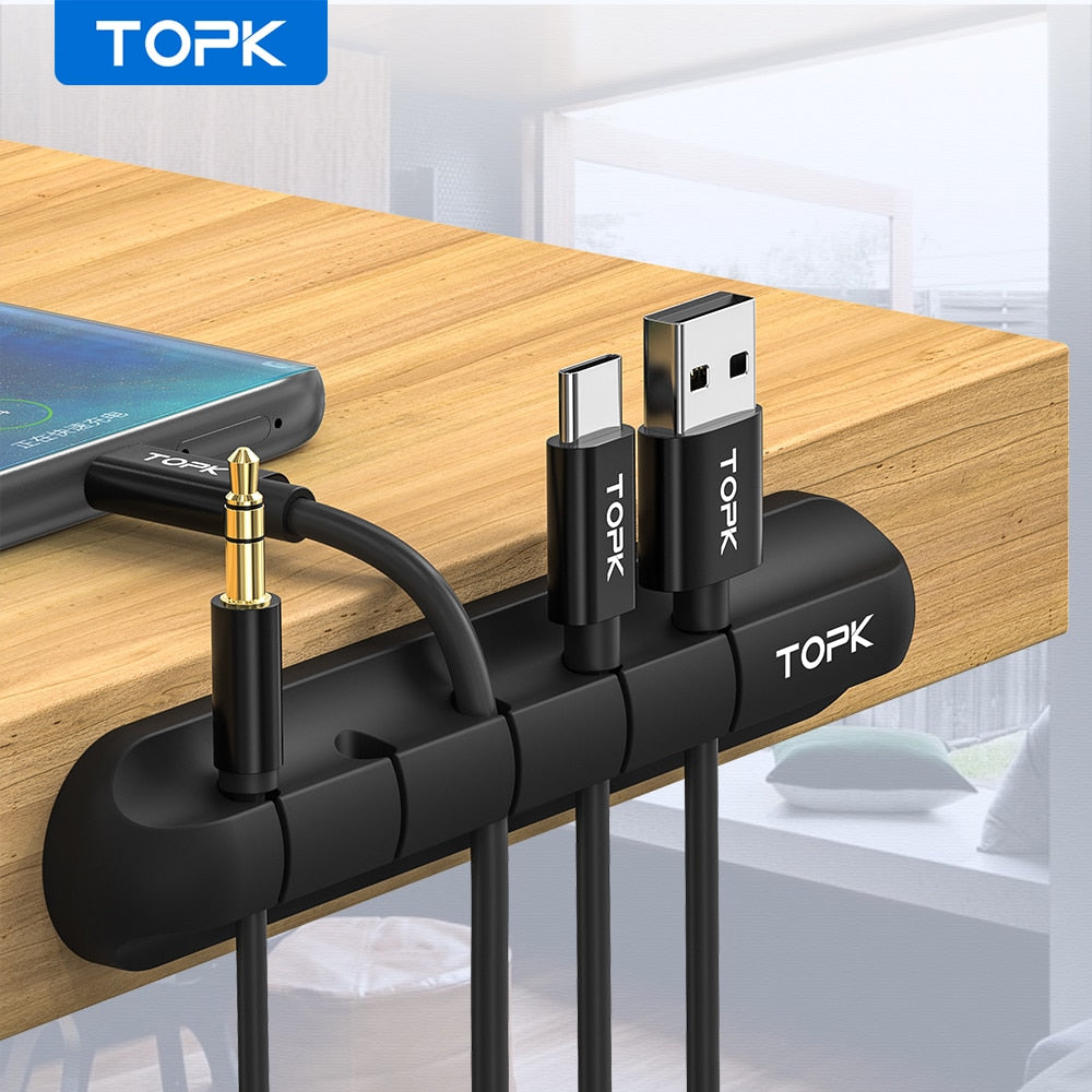 Multiple wire management clips organizing cables on a desktop
