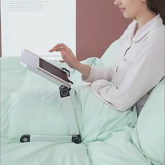 Adjustable foldable laptop stand demonstrating height and angle adjustment for comfortable desk use.