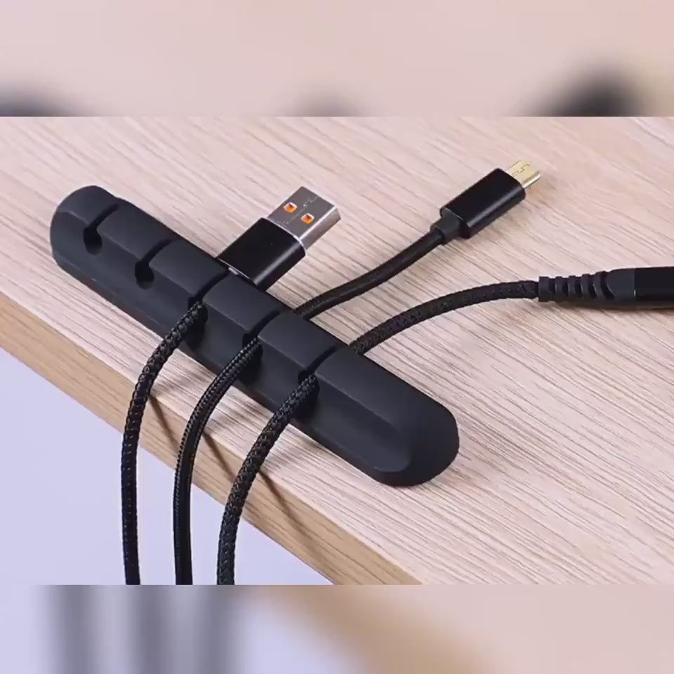 Silicone cable organizer clips demonstrating how to secure charging cables, USB cords, and headphones neatly on a desktop.