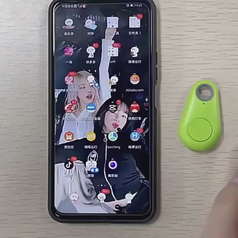 ompact Bluetooth tracker attached to luggage demonstrating its use for travel bags and personal belongings.