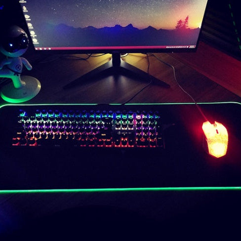 RGB LED gaming mouse pad with colorful lighting effects for desktop setup