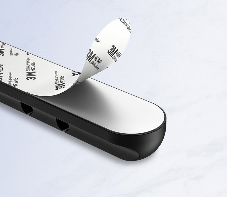 USB cable management clips attached to a desktop for organized cords