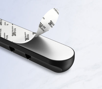 USB cable management clips attached to a desktop for organized cords